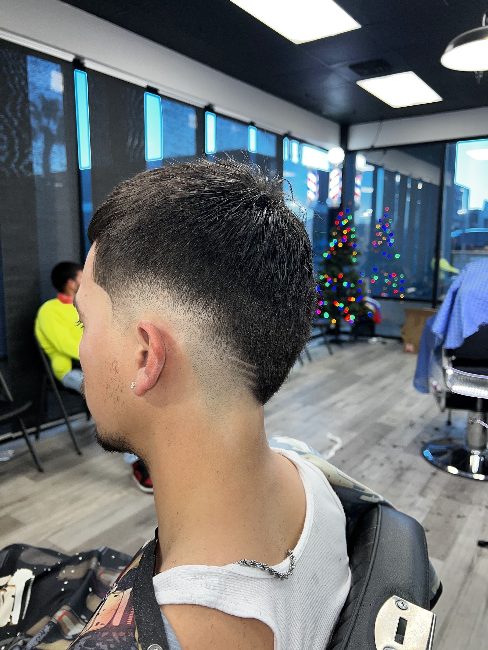 Side view of men's short taper fade haircut in the barbershop