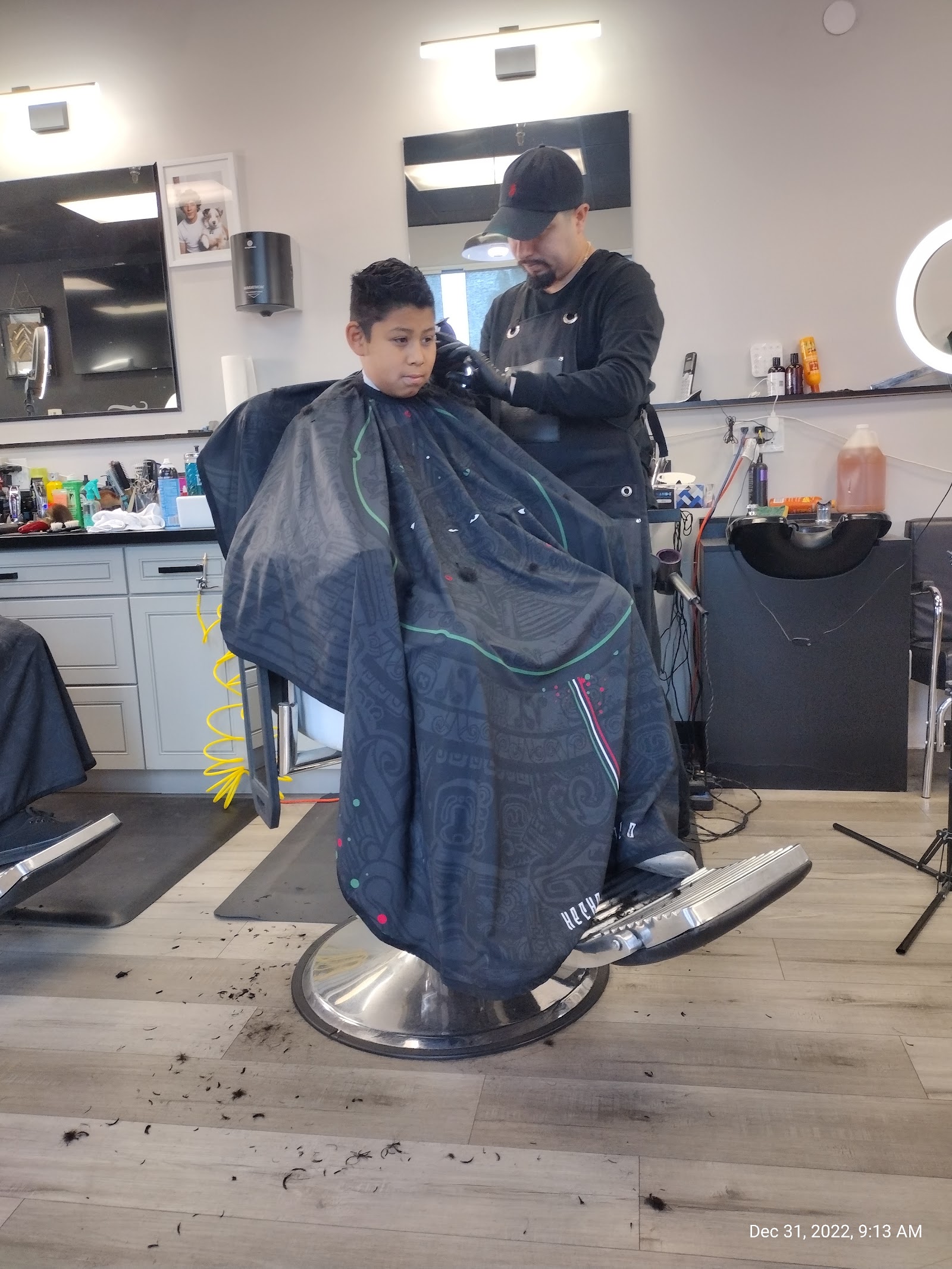 Barber cutting a young boy's hair in the shop